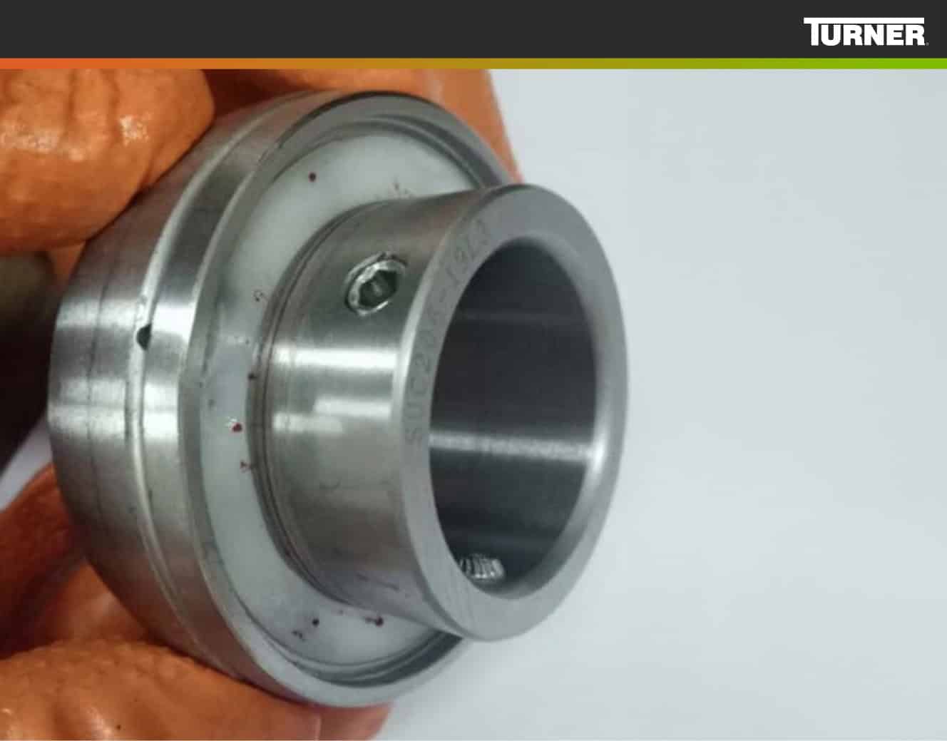 Hand holding a Lubrilife bearing insert to show the polymer fill around the outer race