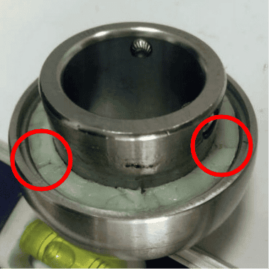 Competitor two's bearing insert, the back-side seal is removed to show the polymer fill. the fill has obvious gaps that leave rolling elements exposed.