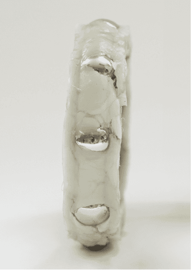 Competitor one's internal elements of the bearing insert. The polymer fill is lumpy and inconsistent.