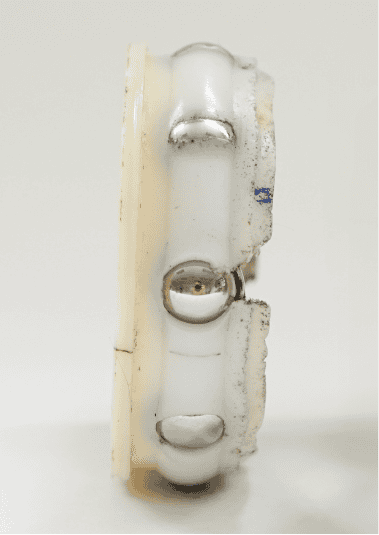 Competitor two's internal elements of the bearing insert. The polymer fill is incomplete, leaving voids.